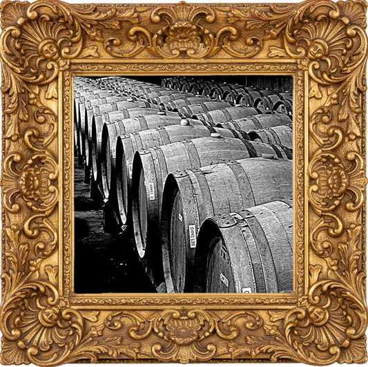 Wooden oak barrels lined up for aging Armagnac brandy in a traditional distillery.